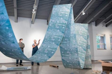 Melissa Haviland talks with Douglas McGlumphy, M.F.A., Olin Art Gallery Director, as she sets up her exhibit in the Olin Fine Art Gallery October 27, 2021 on the campus of Washington & Jefferson College in Washington, Pa.